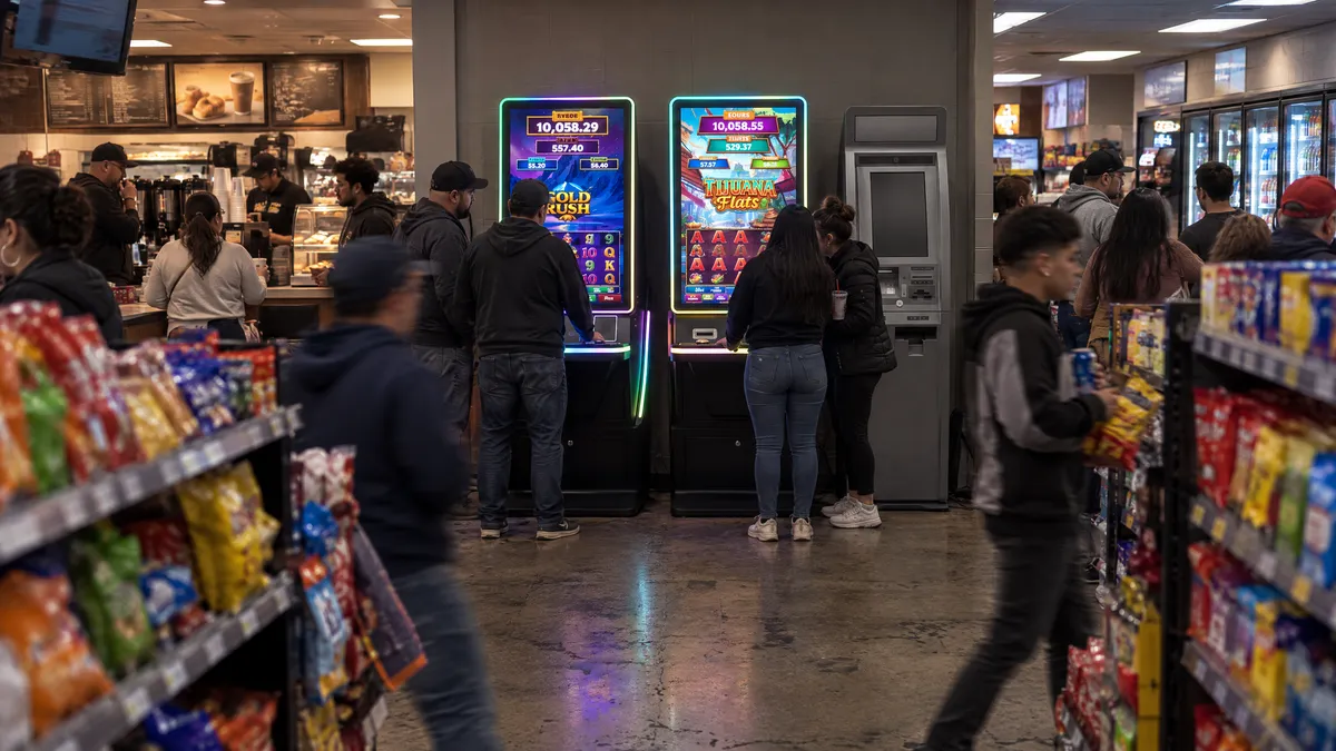 Two Foxfire cabinets and a payout kiosk past the snack aisle of a convenience store
